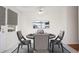 Cozy dining room featuring a round table, modern chairs, and a window with blinds at 1002 Willow Drive # 63, Chapel Hill, NC 27514