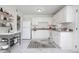 Bright kitchen featuring white cabinetry, appliances, countertops, shelving and island at 1002 Willow Drive # 63, Chapel Hill, NC 27514