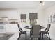 Eat-in kitchen with white cabinetry, modern appliances, and dining set at 1002 Willow Drive # 63, Chapel Hill, NC 27514