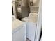 Close up of white Amana brand washer and dryer, with Carrier brand HVAC system at 1002 Willow Drive # 63, Chapel Hill, NC 27514