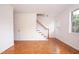 Empty living room showcasing the hardwood floors and staircase at 1002 Willow Drive # 63, Chapel Hill, NC 27514