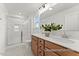 Bathroom featuring dual sinks, wood cabinets, and a glass-enclosed shower at 106 S Buggy Dr # 70, Benson, NC 27504
