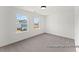 Well-lit bedroom with carpet, large windows, and views of the surrounding neighborhood at 106 S Buggy Dr # 70, Benson, NC 27504