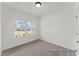 Bright bedroom with plush carpet, white walls, and large windows offering natural light and neighborhood views at 106 S Buggy Dr # 70, Benson, NC 27504