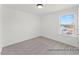 Neutral bedroom featuring carpet, white walls, a modern light fixture, and a bright window at 106 S Buggy Dr # 70, Benson, NC 27504