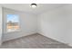 Bedroom featuring neutral carpet and white walls with a large window providing ample natural light at 106 S Buggy Dr # 70, Benson, NC 27504