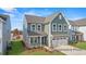 Charming two-story home with gray siding, a well-kept lawn, and a two-car garage at 106 S Buggy Dr # 70, Benson, NC 27504