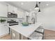 Modern kitchen features an island with seating, stainless steel appliances, and white cabinetry at 106 S Buggy Dr # 70, Benson, NC 27504