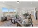 Open-concept living room with large windows, stylish furniture, and a view of the kitchen at 106 S Buggy Dr # 70, Benson, NC 27504