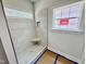 Bright bathroom featuring tiled walk-in shower with a corner seat and a window for natural light at 1079 Fairhaven Dr # 50, Mebane, NC 27302