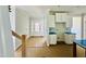 View of kitchen with white cabinets and a large island with blue protection, flowing into the entryway at 1079 Fairhaven Dr # 50, Mebane, NC 27302