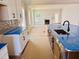Beautiful kitchen with a large island, stainless steel sink, and an adjacent living area with a fireplace at 1079 Fairhaven Dr # 50, Mebane, NC 27302