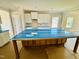 Kitchen island with blue wrapped countertop and view of additional cabinets and windows at 1079 Fairhaven Dr # 50, Mebane, NC 27302