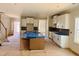 Open-concept kitchen with white cabinets, a center island, and an adjacent living area at 1079 Fairhaven Dr # 50, Mebane, NC 27302