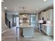 Open-concept kitchen featuring a large island, modern lighting, and stainless steel appliances adjacent to the living area at 1079 Fairhaven Dr # 50, Mebane, NC 27302