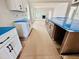 Long kitchen features white cabinets and a large island with blue protective wrapping at 1079 Fairhaven Dr # 50, Mebane, NC 27302