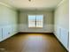 Living room with gray walls, white trim, and a large window providing plenty of natural light at 1079 Fairhaven Dr # 50, Mebane, NC 27302