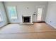 Living room features a fireplace, white trim and views of the yard at 1079 Fairhaven Dr # 50, Mebane, NC 27302