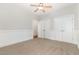 Bright bedroom with carpet, wainscoting, ceiling fan, closet and doorway to another room at 1096 Silverleaf Dr, Youngsville, NC 27596