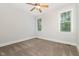 Cozy bedroom with neutral carpet, ceiling fan, and natural light from two windows at 1096 Silverleaf Dr, Youngsville, NC 27596