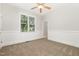 Light bedroom with carpet, wainscoting, ceiling fan, and bright window at 1096 Silverleaf Dr, Youngsville, NC 27596