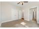 Bright bedroom with carpet, closet, ceiling fan, and view to bathroom at 1096 Silverleaf Dr, Youngsville, NC 27596