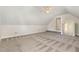 A spacious bonus room featuring neutral paint, patterned carpet, and ceiling fan, perfect for a flexible living space at 1096 Silverleaf Dr, Youngsville, NC 27596
