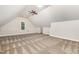 Spacious bonus room with neutral paint, patterned carpet, ceiling fan, and natural light from a window at 1096 Silverleaf Dr, Youngsville, NC 27596