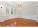 Elegant dining room featuring hardwood floors, wainscoting, and a classic chandelier at 1096 Silverleaf Dr, Youngsville, NC 27596