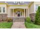 Inviting front entry with stone steps and pillars, well-maintained landscaping, and a dark wood front door at 1096 Silverleaf Dr, Youngsville, NC 27596
