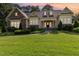 Charming two-story home featuring stone accents, manicured landscaping, and inviting front porch under a colorful sunset sky at 1096 Silverleaf Dr, Youngsville, NC 27596