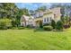 Charming two-story home featuring stone accents, manicured landscaping, and inviting front porch on a sunny day at 1096 Silverleaf Dr, Youngsville, NC 27596
