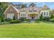 Charming two-story home featuring stone accents, manicured landscaping, and inviting front porch on a sunny day at 1096 Silverleaf Dr, Youngsville, NC 27596