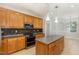 Well-equipped kitchen showcasing wood cabinets, an island, and modern stainless appliances at 1096 Silverleaf Dr, Youngsville, NC 27596