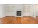 Bright living room featuring hardwood floors, a fireplace with built-in bookshelves, and recessed lighting at 1096 Silverleaf Dr, Youngsville, NC 27596