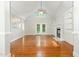 Spacious living room with hardwood floors, a fireplace with built-in bookshelves, and french doors to the backyard at 1096 Silverleaf Dr, Youngsville, NC 27596