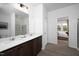 Bathroom with double sink vanity, quartz countertops, framed mirror and modern lighting at 11751 Salers Loop Loop, Middlesex, NC 27557