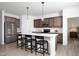 A modern kitchen offers an island with bar seating, pendant lights, and stainless steel appliances at 11751 Salers Loop Loop, Middlesex, NC 27557
