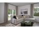 A cozy living room with neutral colors, layered pillows on a couch and an abstract artwork at 11751 Salers Loop Loop, Middlesex, NC 27557