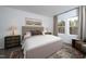 Cozy bedroom features a neutral color palette, and patterned rug under the bed at 11751 Salers Loop Loop, Middlesex, NC 27557