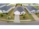 Aerial view featuring a one-story home with a paved driveway, landscaping, and an attached garage at 119 Yadkin St, Clayton, NC 27520