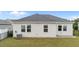 View of the gray vinyl siding and maintained lawn area in this home's backyard at 119 Yadkin St, Clayton, NC 27520