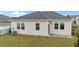 Exterior view of the home's backyard featuring gray vinyl siding and a well-manicured lawn at 119 Yadkin St, Clayton, NC 27520