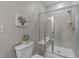 Shower with a built-in bench, decorative wall art, and neutral wall paint at 119 Yadkin St, Clayton, NC 27520