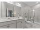 Bright bathroom features double sinks, white cabinets, and a shower with glass enclosure at 119 Yadkin St, Clayton, NC 27520