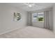Neutral bedroom with a ceiling fan, large window, and soft carpeting at 119 Yadkin St, Clayton, NC 27520