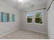 Bedroom with neutral carpet, ceiling fan, and a double window at 119 Yadkin St, Clayton, NC 27520