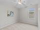 Bedroom with neutral carpet, ceiling fan, and a large window at 119 Yadkin St, Clayton, NC 27520