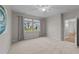 Bright bedroom with soft carpeting, ceiling fan, and a picturesque window view at 119 Yadkin St, Clayton, NC 27520