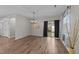 Elegant dining area with an ornate chandelier, wood flooring, and glass sliding door at 119 Yadkin St, Clayton, NC 27520